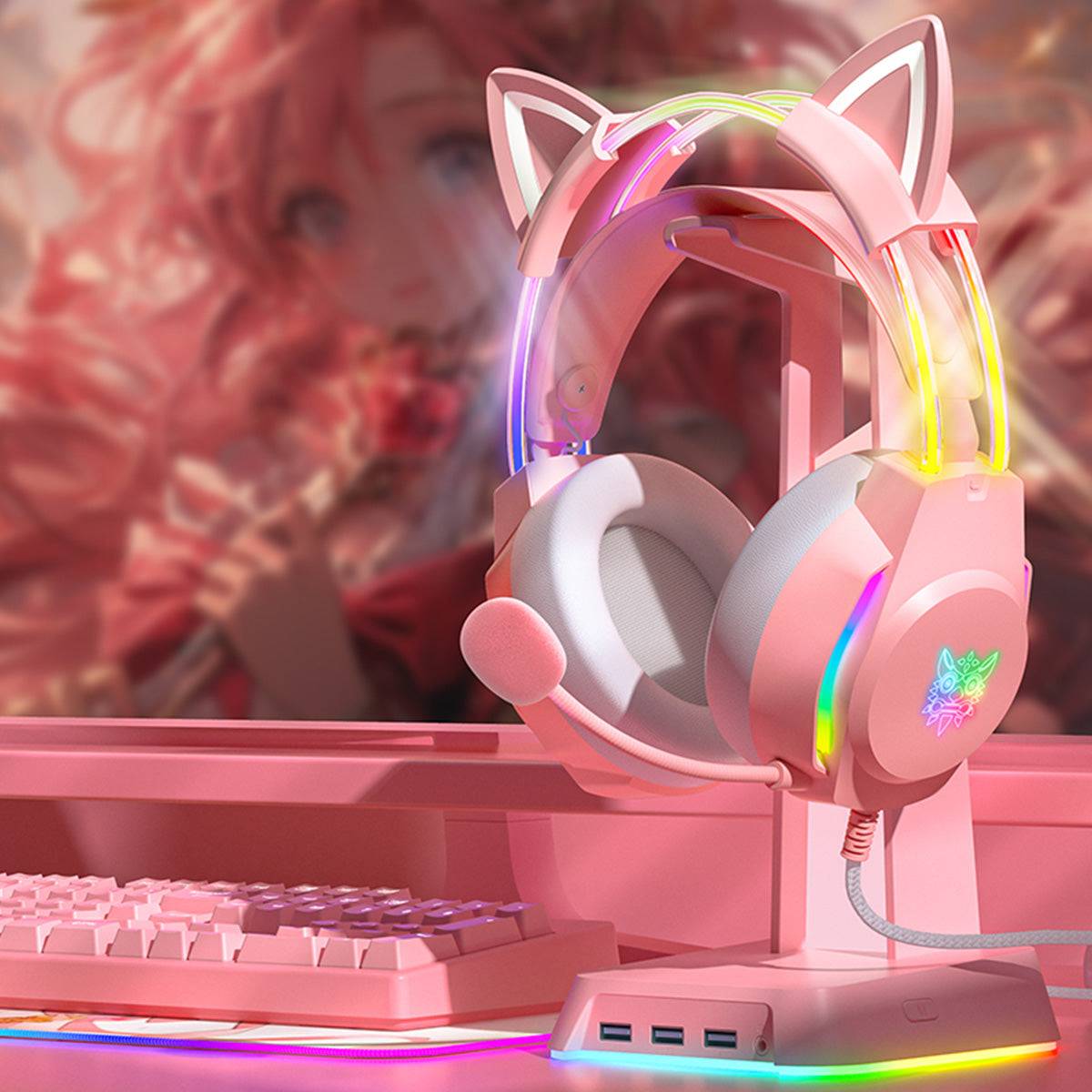 ONIKUMA X26 Cat Ear RGB Gaming Headset in a pink-themed gaming setup, featuring vibrant LED lighting and a comfortable design for immersive play.